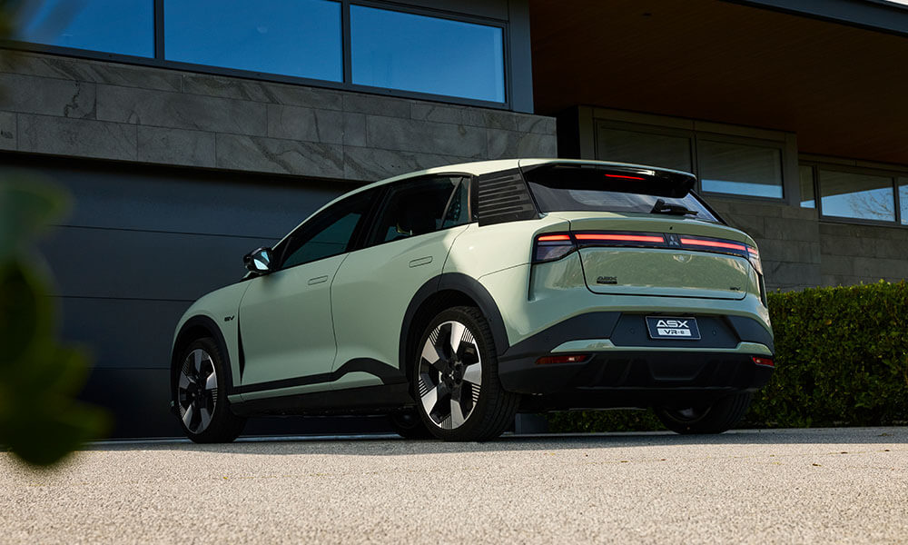 Rear angle image of a green electric SUV