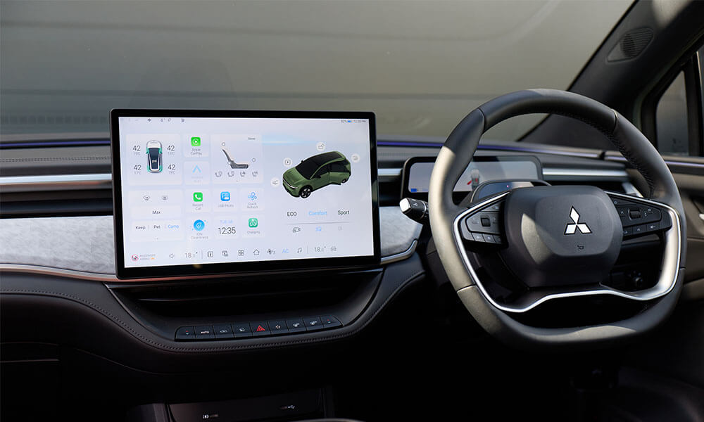 Close up image of an infotainment screen and steering wheel