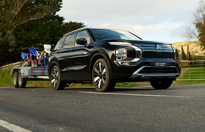 A black Outlander PHEV towing a trailer