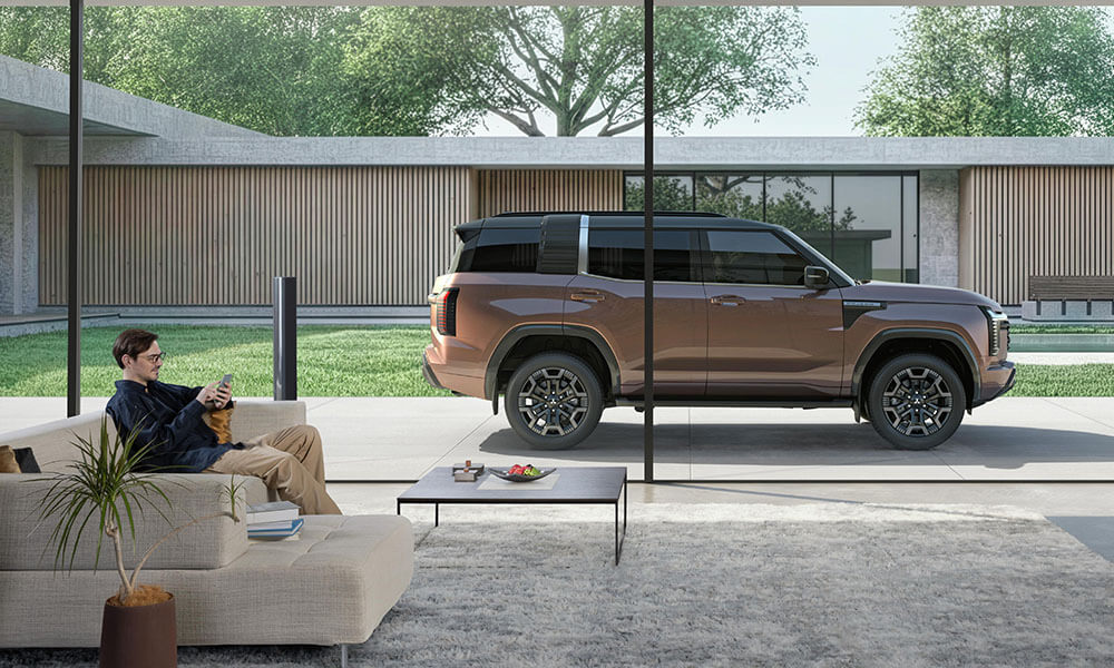 Side profile of a Pajero parked behind a glass wall