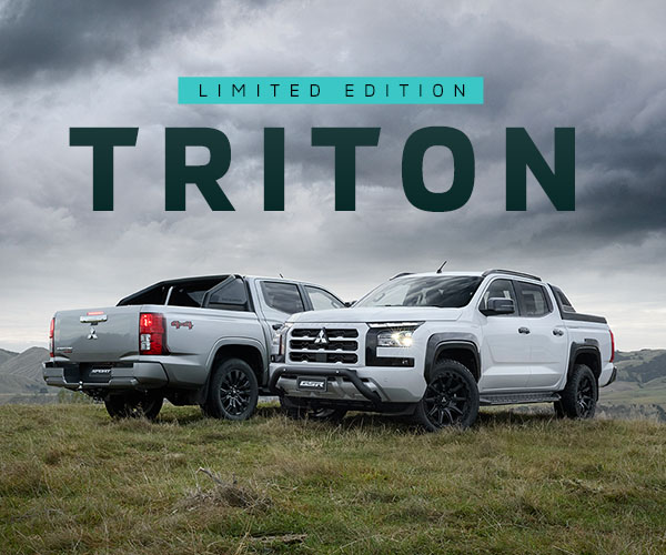 2 limited editions triton utes parked on a grassy hill