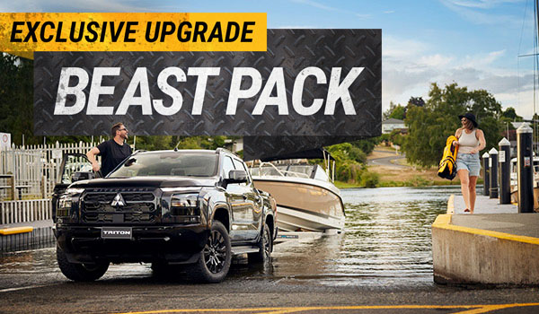 A black ute towing a boat out of water with a Beast Pack graphic in the top left corner