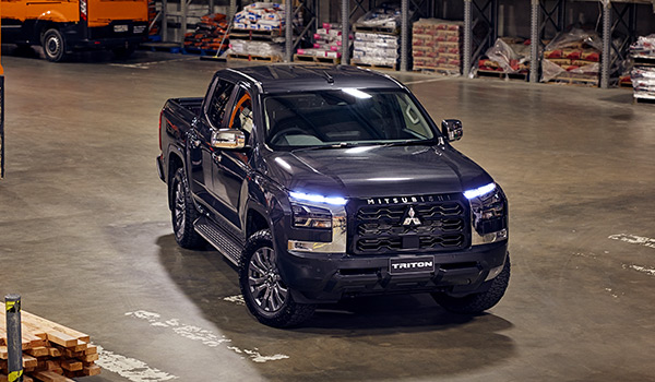 A black ute parked in a warehouse